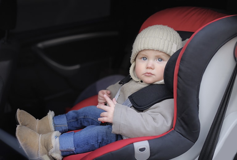 What happens if we put a child wearing a coat in a child seat?